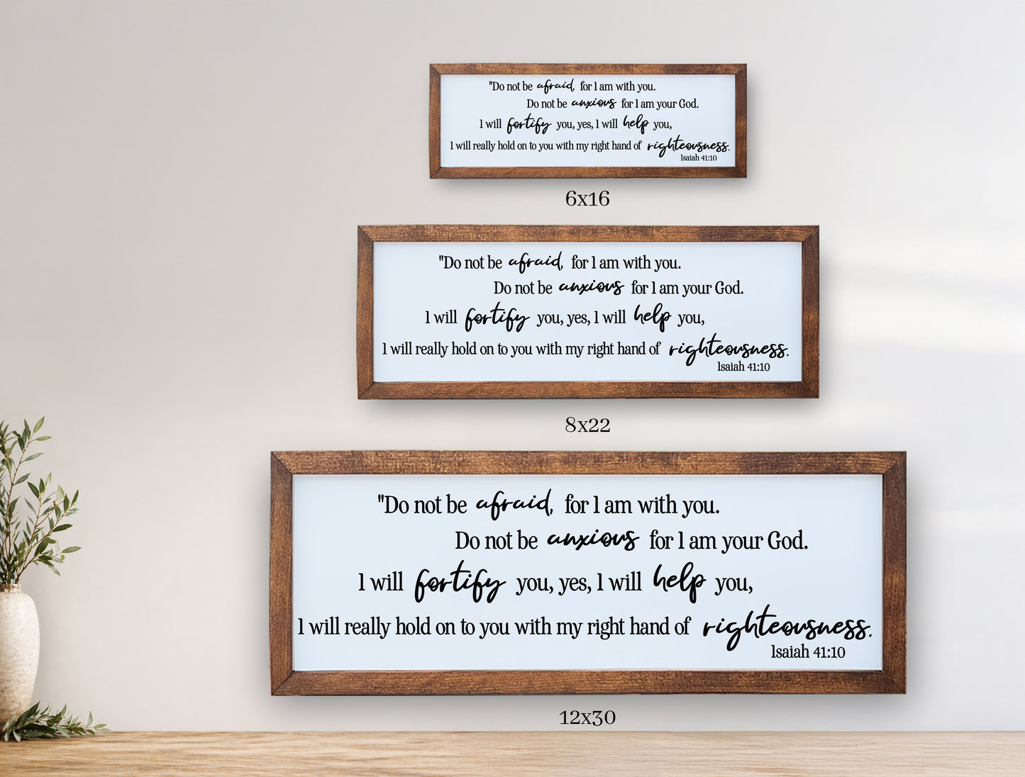 Three framed prints with biblical verses on a wall.