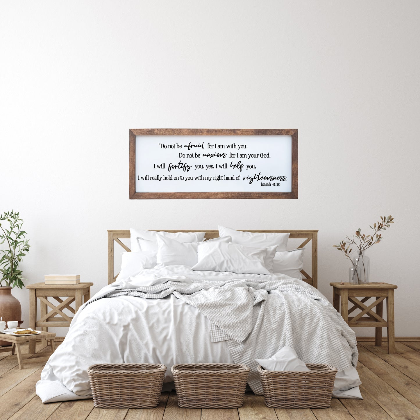 Bedroom with wooden headboard, white bedding, and framed text on wall.