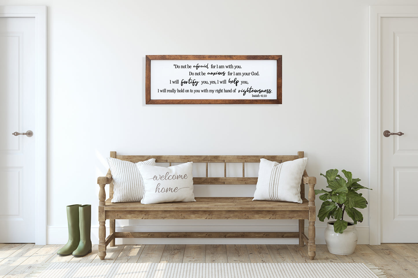 Wooden bench with pillows in a room with a framed quote on the wall.