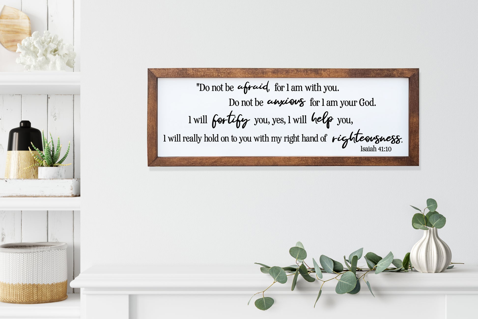 Wooden framed sign with Bible verse on a white wall with decorative elements.
