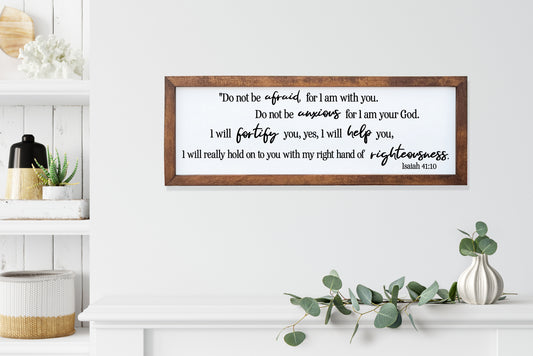 Wooden framed sign with Bible verse on a white wall with decorative elements.