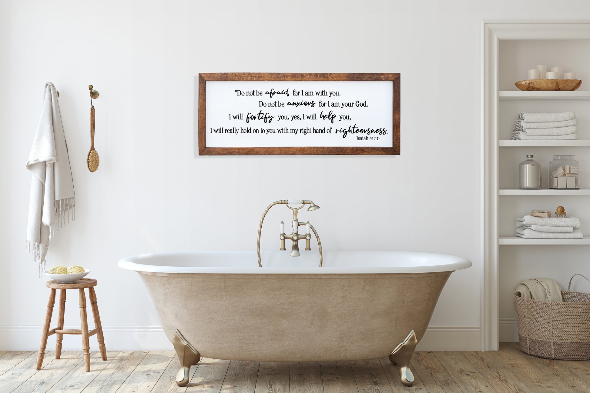 Bathroom with a freestanding bathtub, wooden stool, and framed text on the wall.